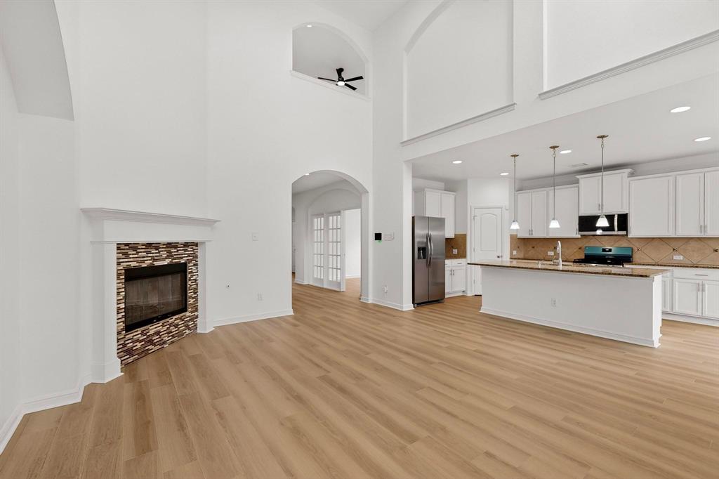 174 Hampton Drive Fate, TX 75087 - Photo 5 of 40 a view of kitchen with granite countertop cabinets and refrigerator