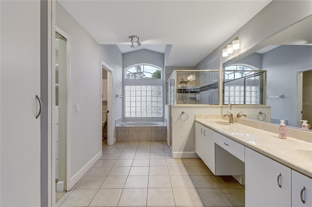 16 Edgar Lane Palm Coast, FL 32164 - Photo 19 of 53 a spacious bathroom with a granite countertop sink a mirror and a bathtub