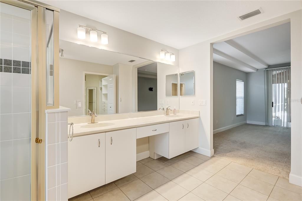 16 Edgar Lane Palm Coast, FL 32164 - Photo 23 of 53 a spacious bathroom with a double vanity sink and a mirror