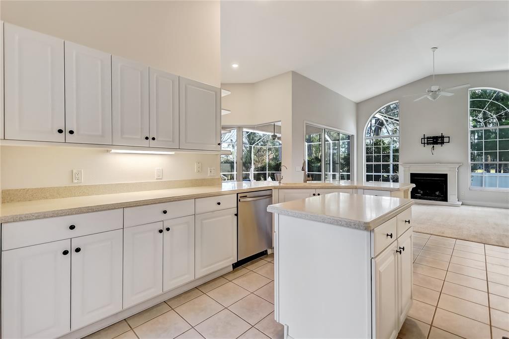 16 Edgar Lane Palm Coast, FL 32164 - Photo 28 of 53 a kitchen with granite countertop a sink and white cabinets