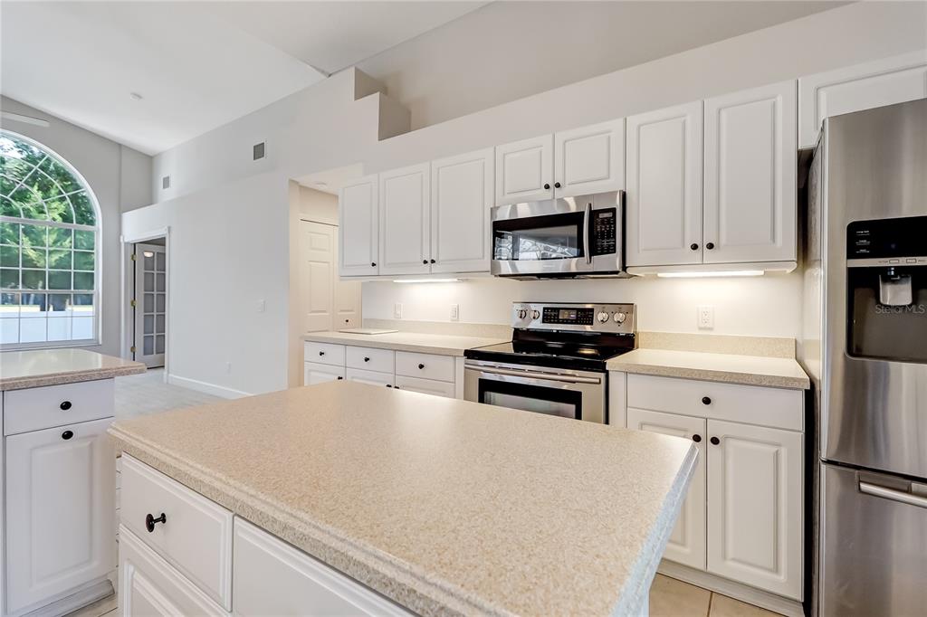 16 Edgar Lane Palm Coast, FL 32164 - Photo 29 of 53 a kitchen with appliances a sink and cabinets