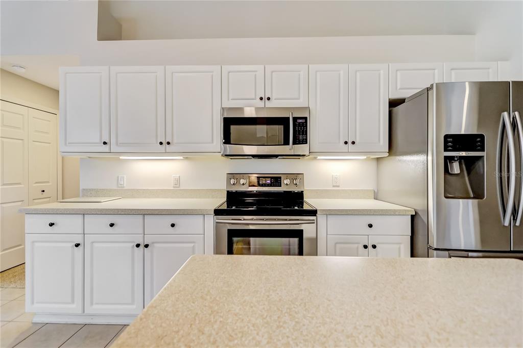 16 Edgar Lane Palm Coast, FL 32164 - Photo 32 of 53 a kitchen with granite countertop white cabinets and stainless steel appliances