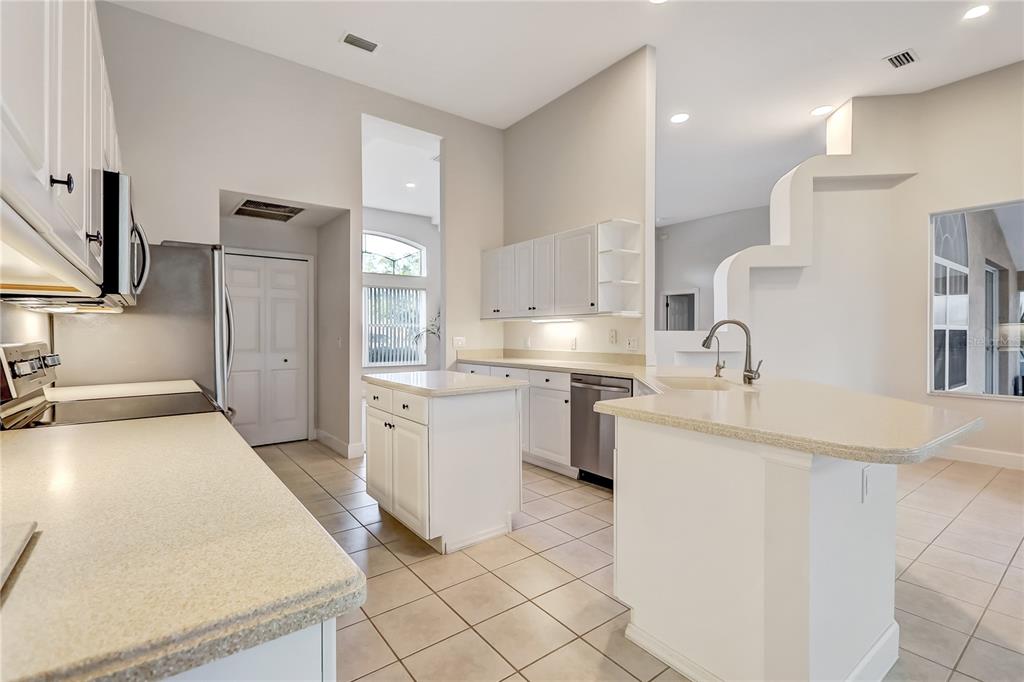 16 Edgar Lane Palm Coast, FL 32164 - Photo 33 of 53 a kitchen with white cabinets and sink
