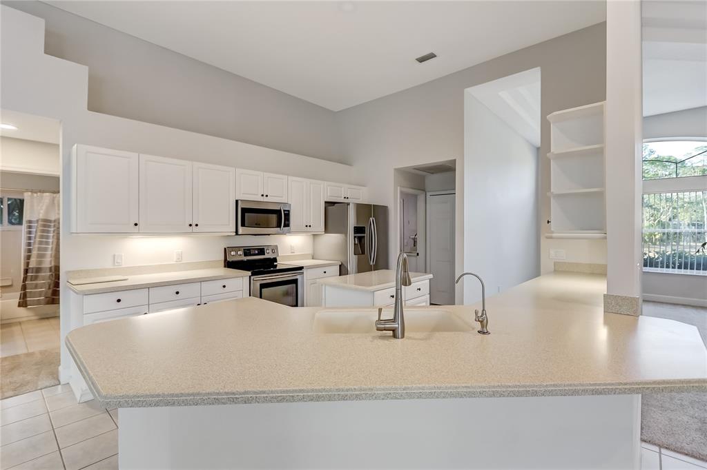 16 Edgar Lane Palm Coast, FL 32164 - Photo 34 of 53 a kitchen with kitchen island a sink appliances and cabinets
