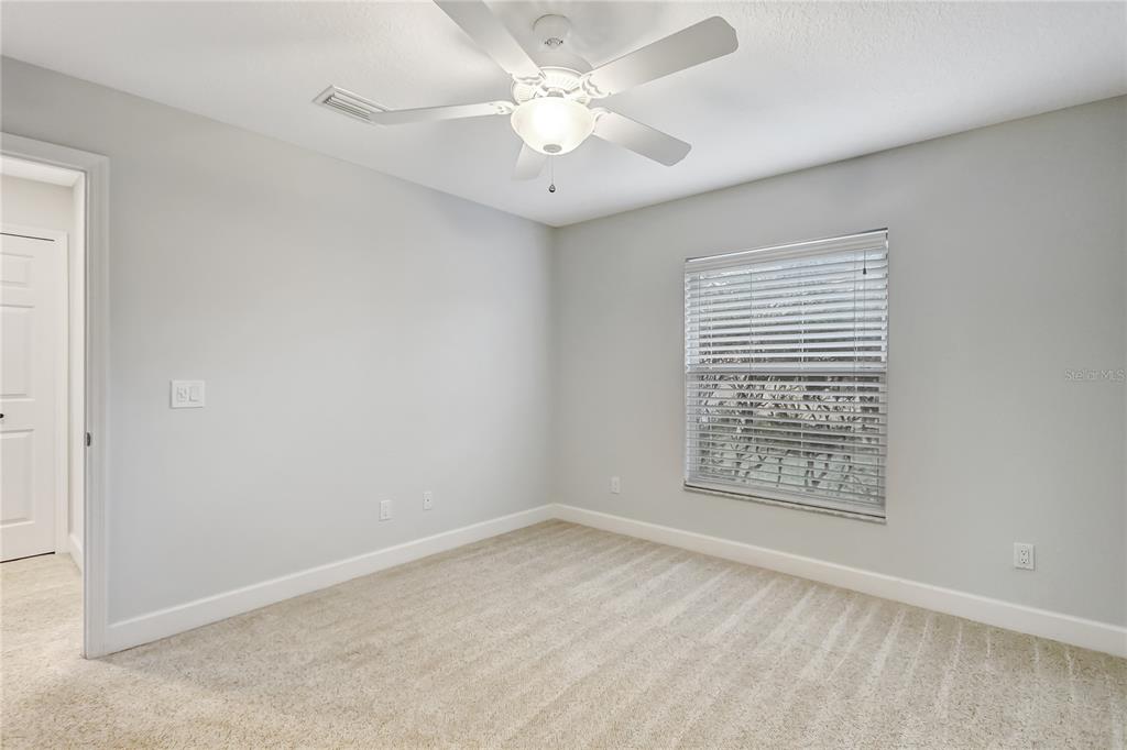 16 Edgar Lane Palm Coast, FL 32164 - Photo 43 of 53 an empty room with windows and fan