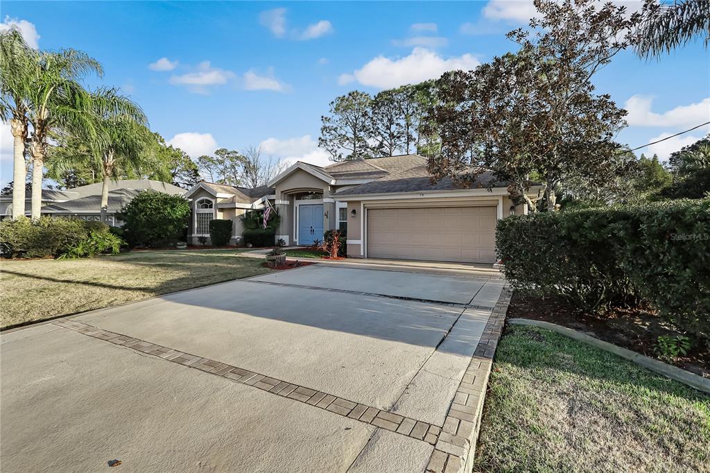 16 Edgar Lane Palm Coast, FL 32164 - Photo 50 of 53 a front view of a house with a yard and trees