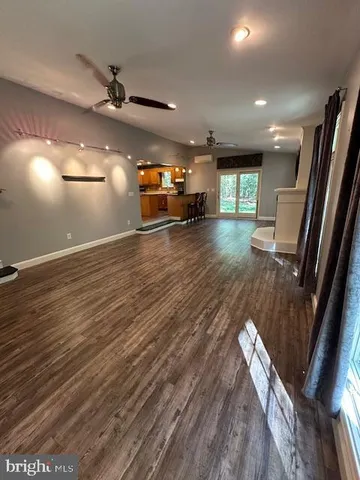 a living room with a fireplace and a large window