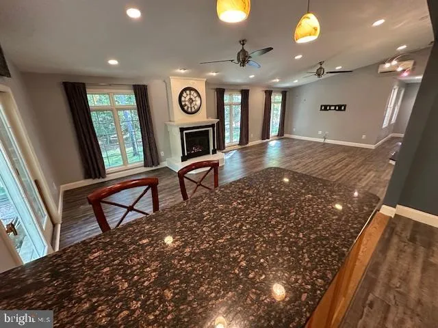 a large kitchen with granite countertop a large counter top stainless steel appliances and cabinets