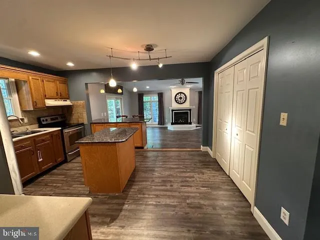 a view of a room with wooden floor and window