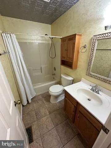 a living room with furniture and stairs