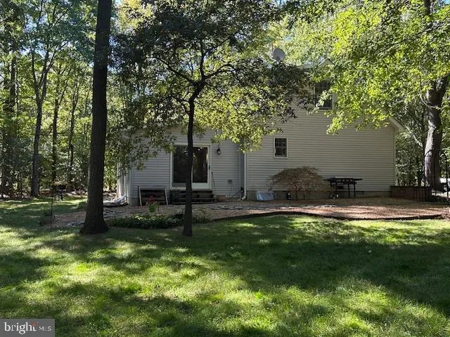 a backyard of a house with table and chairs