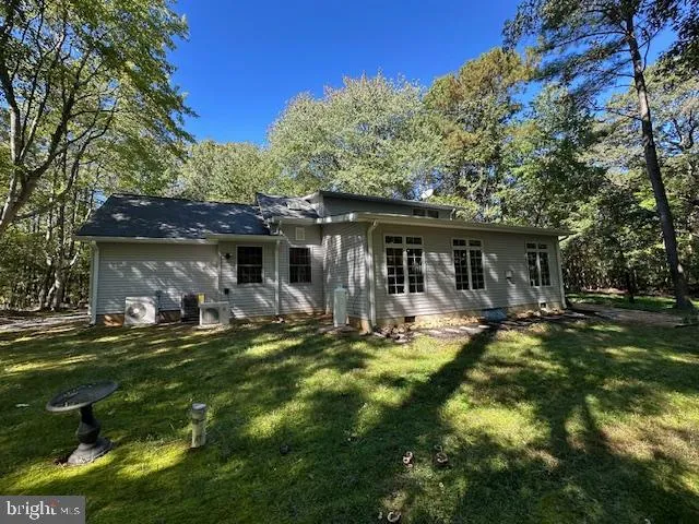 a front view of house with yard outdoor seating and green space