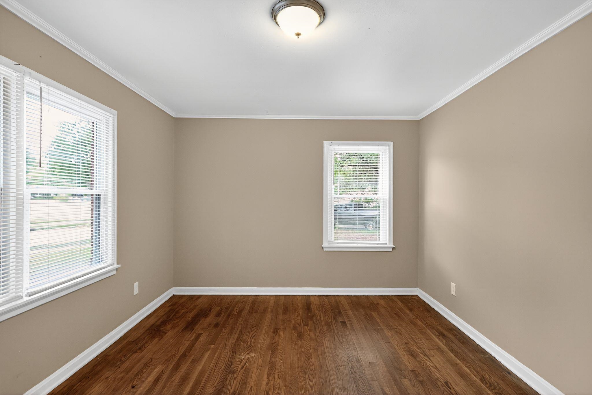 1563 Flamingo Road Memphis, TN 38117 - Photo 19 of 33 Unfurnished room featuring dark wood-type flooring and ornamental molding