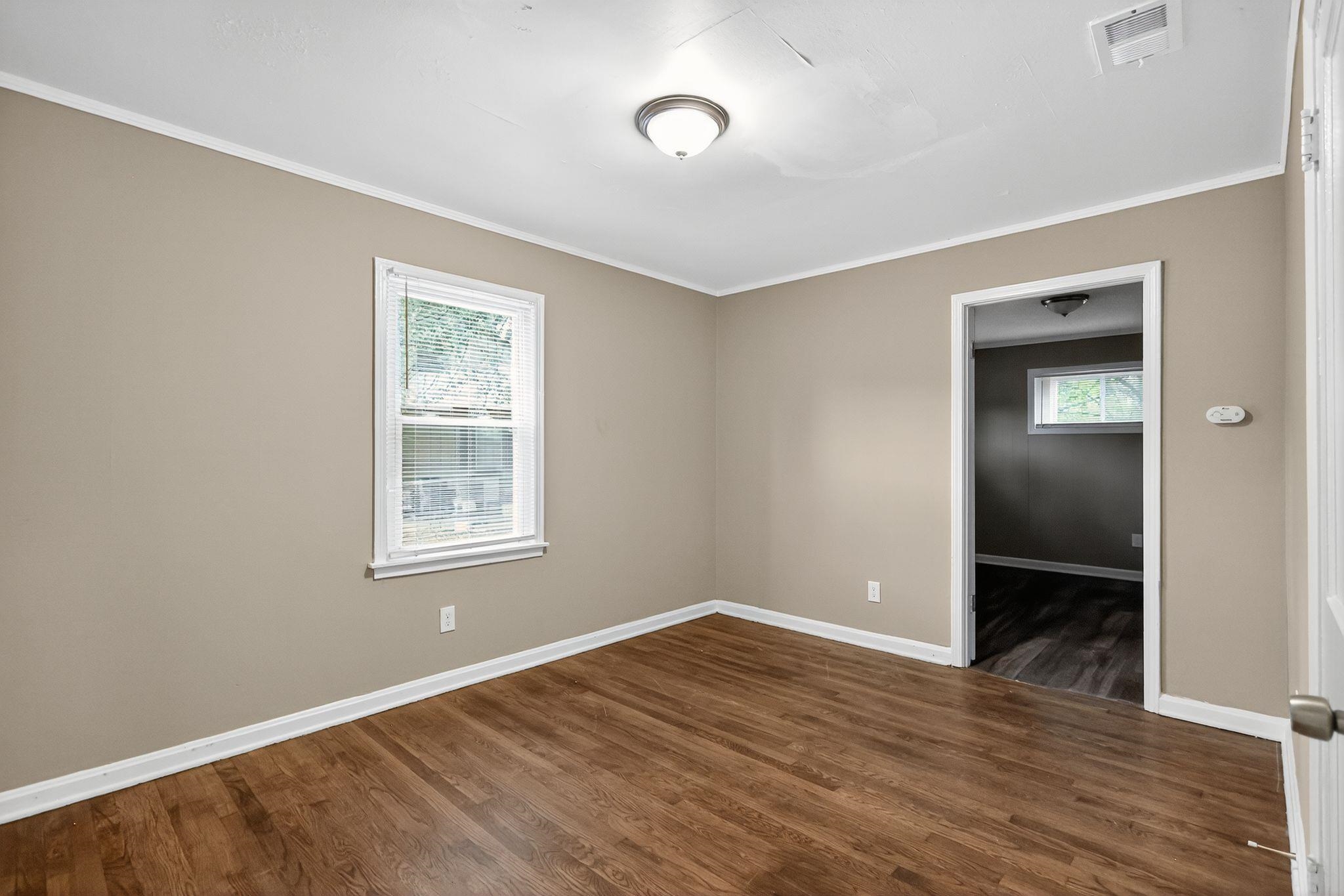 1563 Flamingo Road Memphis, TN 38117 - Photo 2 of 33 Unfurnished room with dark wood finished floors and ornamental molding