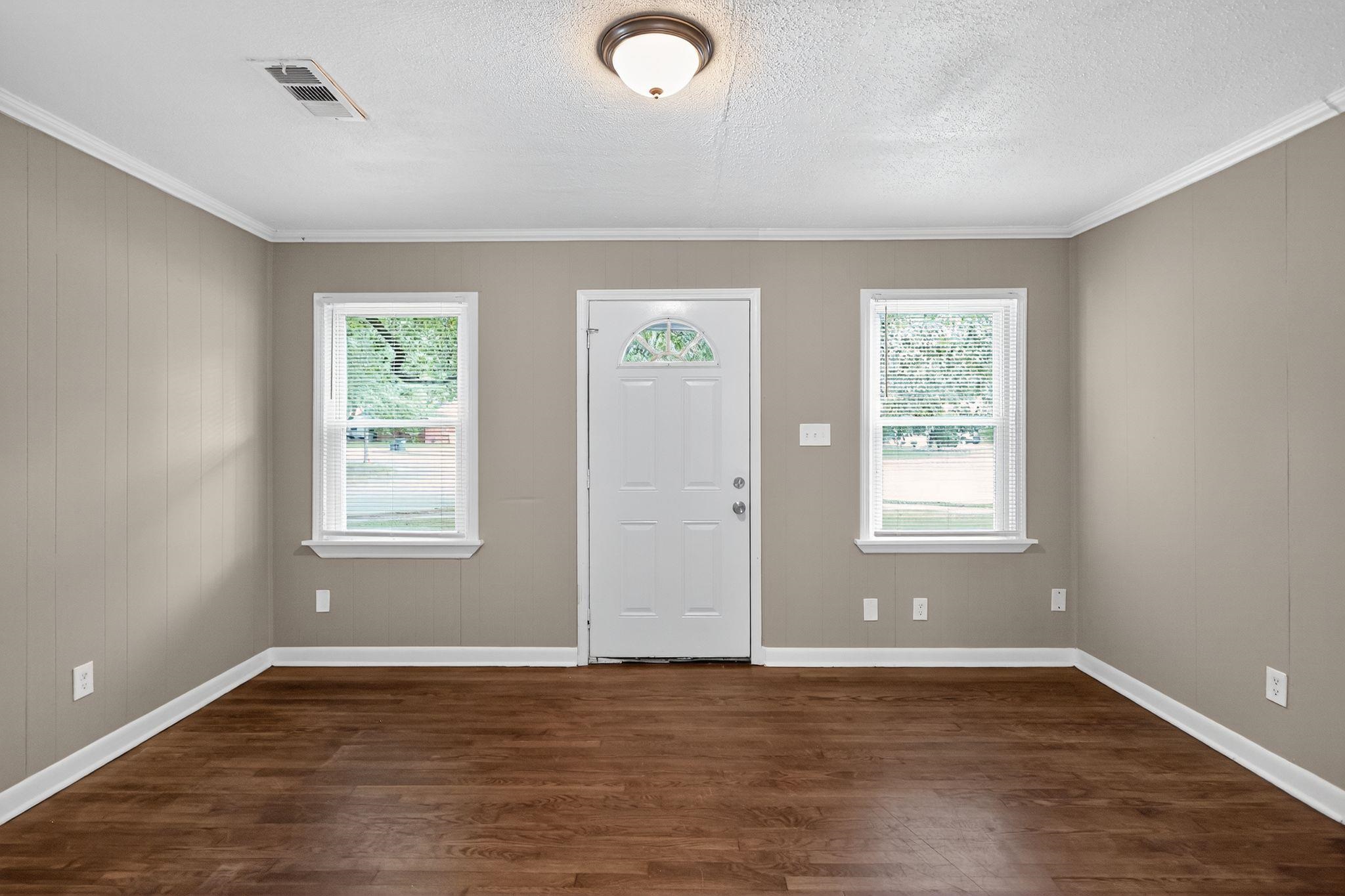 1563 Flamingo Road Memphis, TN 38117 - Photo 21 of 33 Entryway with crown molding, healthy amount of natural light, dark wood finished floors, and a textured ceiling