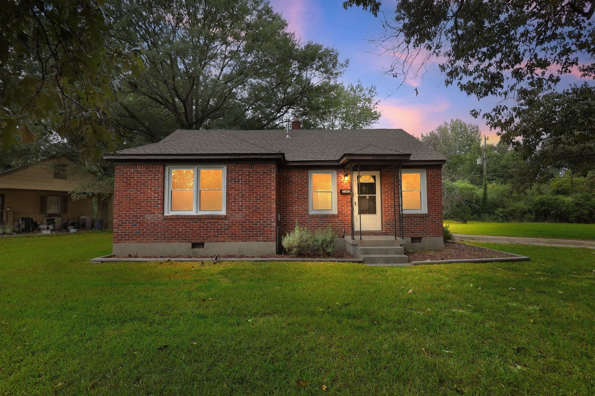 1563 Flamingo Road Memphis, TN 38117 - Photo 24 of 33 View of front of house with crawl space, brick siding, a lawn, and a shingled roof