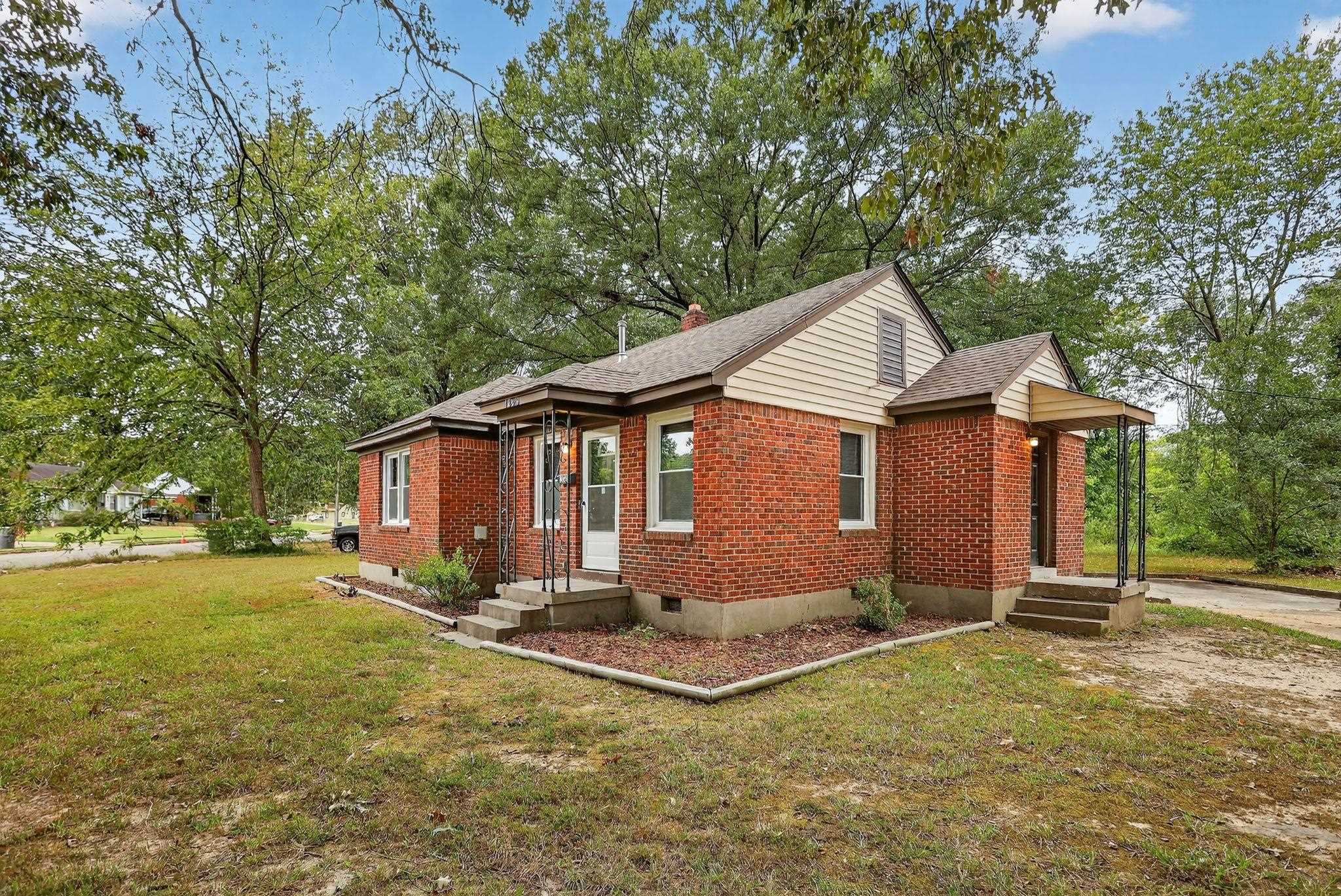 1563 Flamingo Road Memphis, TN 38117 - Photo 26 of 33 View of front of house with brick siding, crawl space, a front yard, roof with shingles, and view of scattered trees
