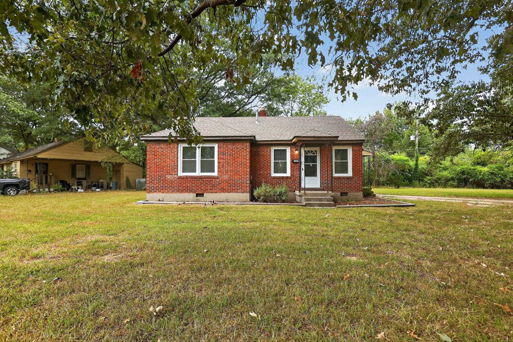 1563 Flamingo Road Memphis, TN 38117 - Photo 30 of 33 View of front of house featuring crawl space, brick siding, a front yard, and a chimney