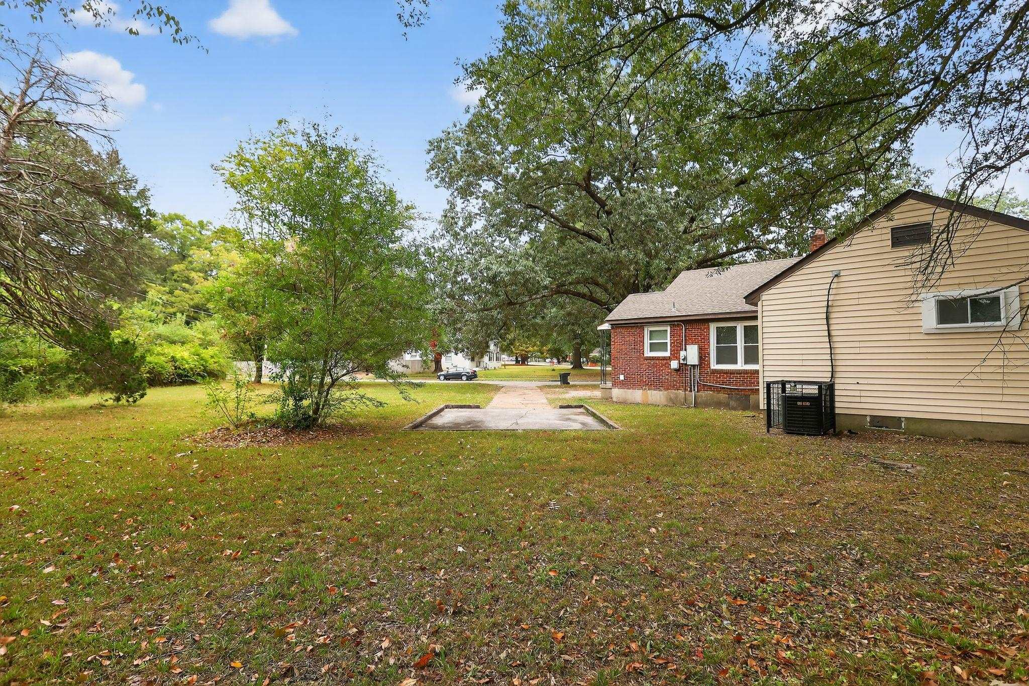 1563 Flamingo Road Memphis, TN 38117 - Photo 32 of 33 View of grassy yard featuring a patio area