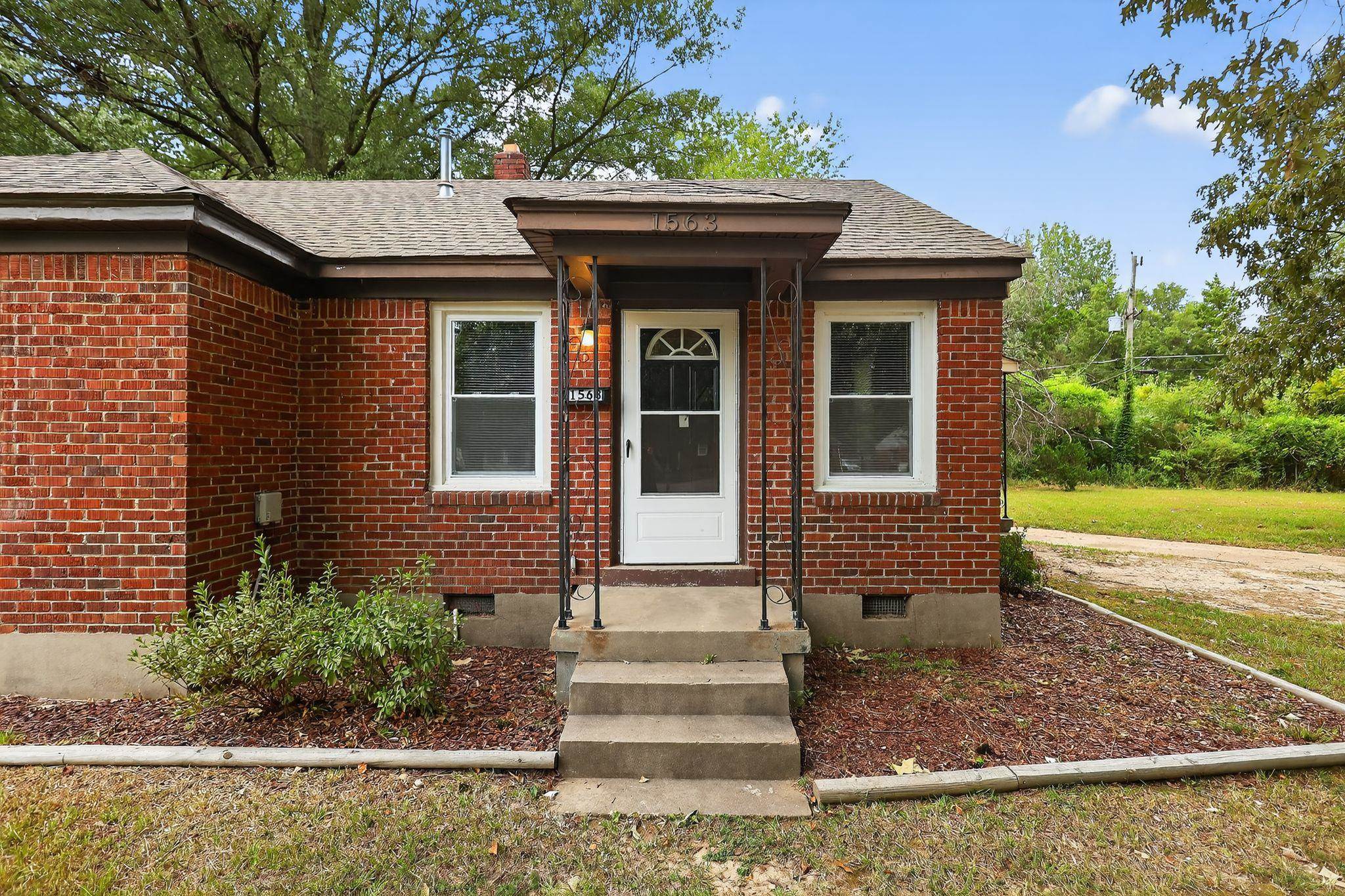 1563 Flamingo Road Memphis, TN 38117 - Photo 33 of 33 View of front facade with brick siding, crawl space, a chimney, and roof with shingles