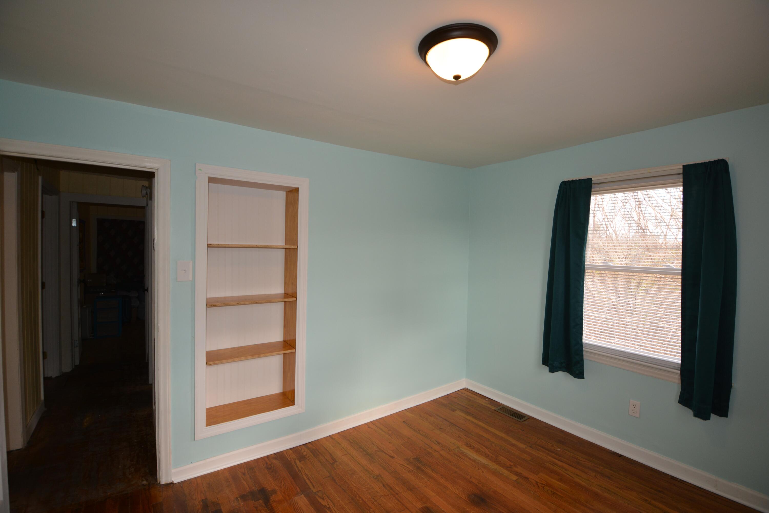 3316 Bassett Heights Road Bassett, VA 24055 - Photo 18 of 51 an empty room with wooden floor and windows