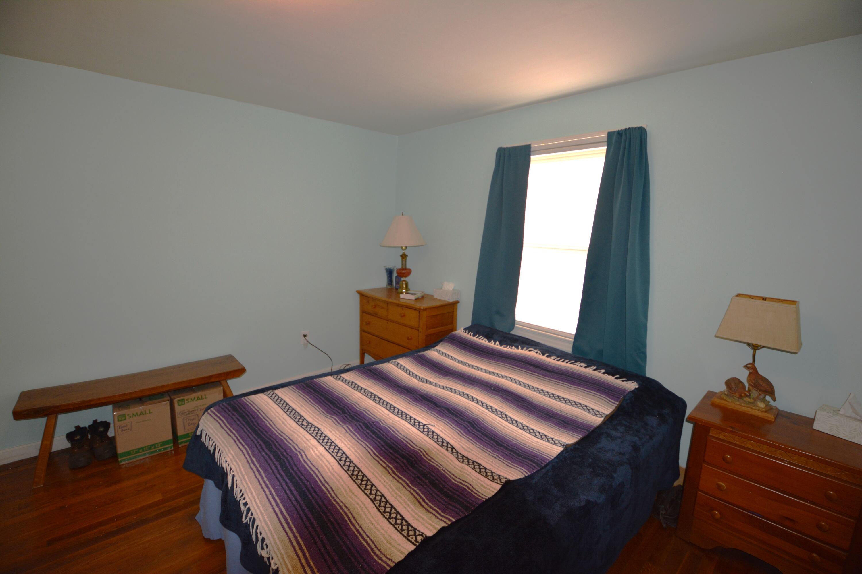 3316 Bassett Heights Road Bassett, VA 24055 - Photo 22 of 51 a bedroom with a bed and wooden floor