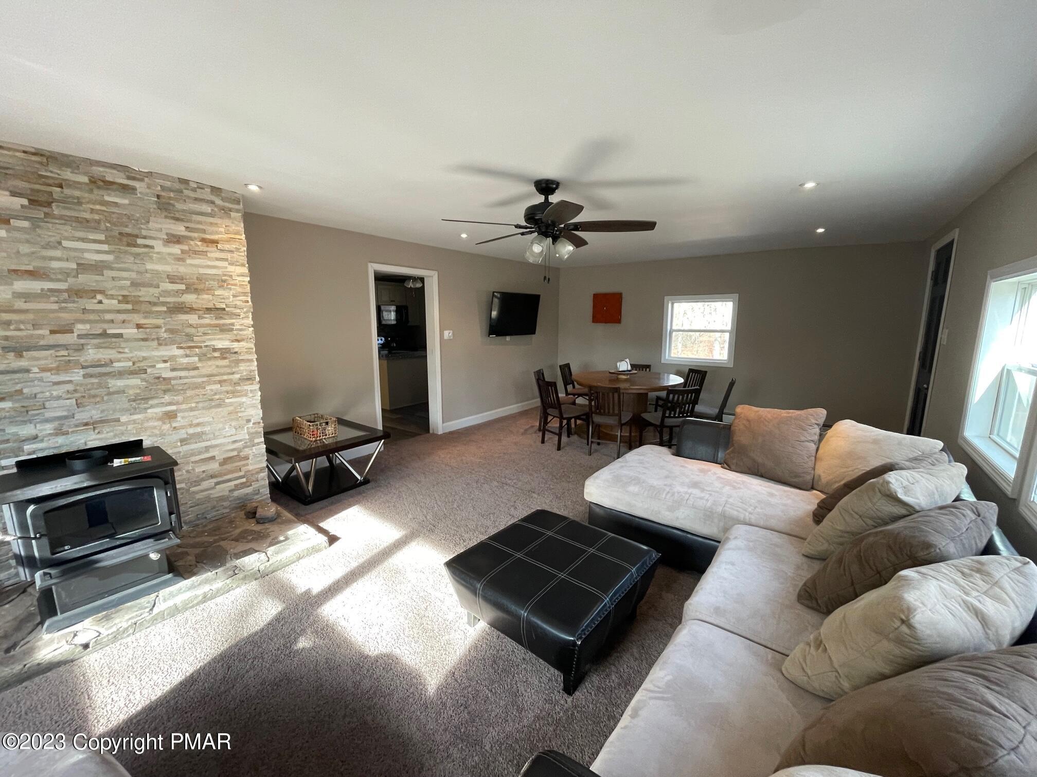83 Fox Hill Road Albrightsville, PA 18210 - Photo 13 of 22 a living room with furniture fireplace and a flat screen tv