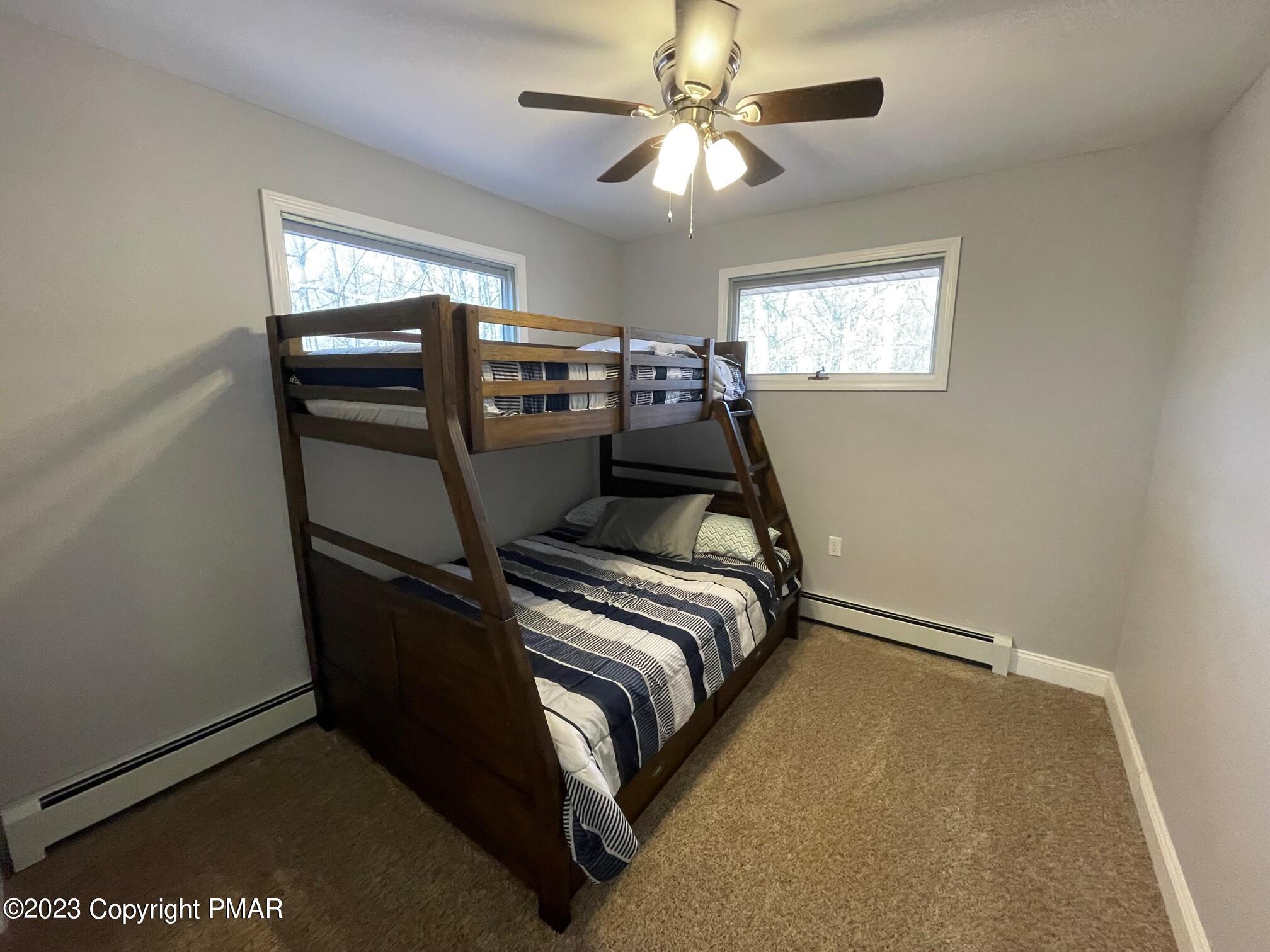 83 Fox Hill Road Albrightsville, PA 18210 - Photo 19 of 22 a bed room with a bed and a chandelier