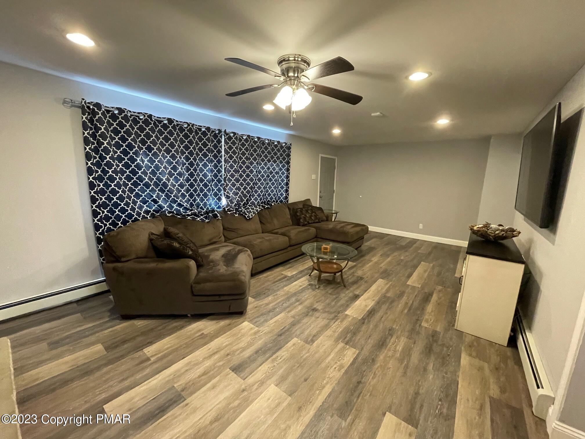 83 Fox Hill Road Albrightsville, PA 18210 - Photo 6 of 22 a living room with furniture and a chandelier