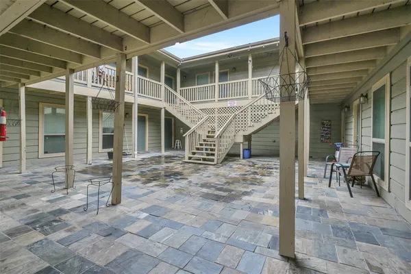 a view of a porch with a table and chairs