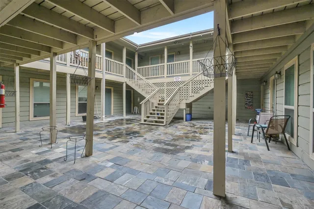 a view of a porch with a table and chairs