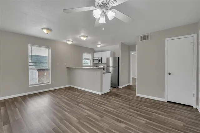 a view of kitchen and hall with wooden floor