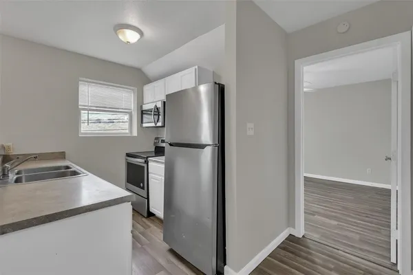 a kitchen with a refrigerator and a stove