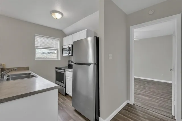 a kitchen with a refrigerator and a stove
