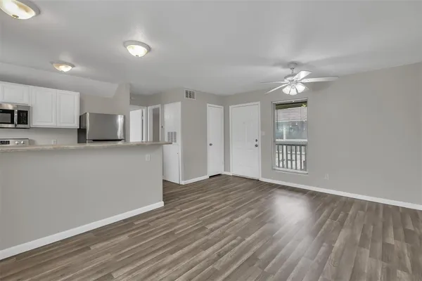 a view of a kitchen with an empty space and a window
