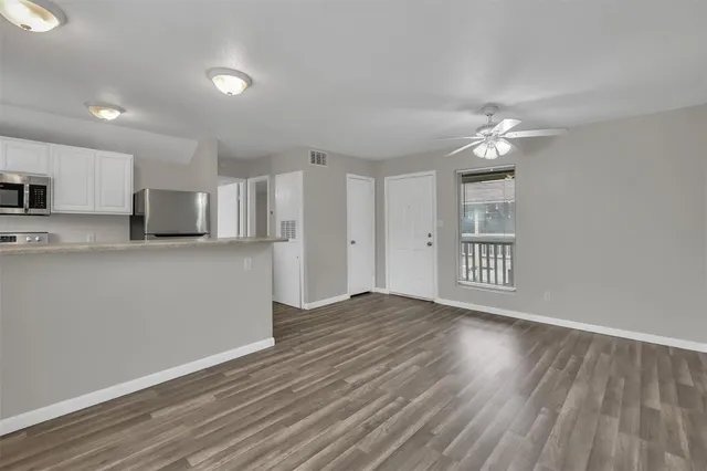 a view of a kitchen with an empty space and a window