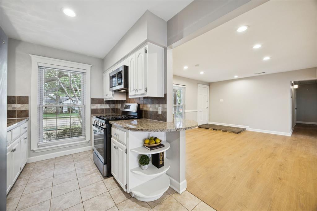 2015 Sandy Trail Richardson, TX 75080 - Photo 10 of 19 a kitchen with stainless steel appliances granite countertop a stove a sink and a microwave