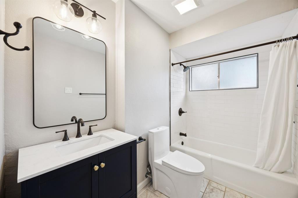 2015 Sandy Trail Richardson, TX 75080 - Photo 14 of 19 a bathroom with a double vanity sink toilet mirror and shower