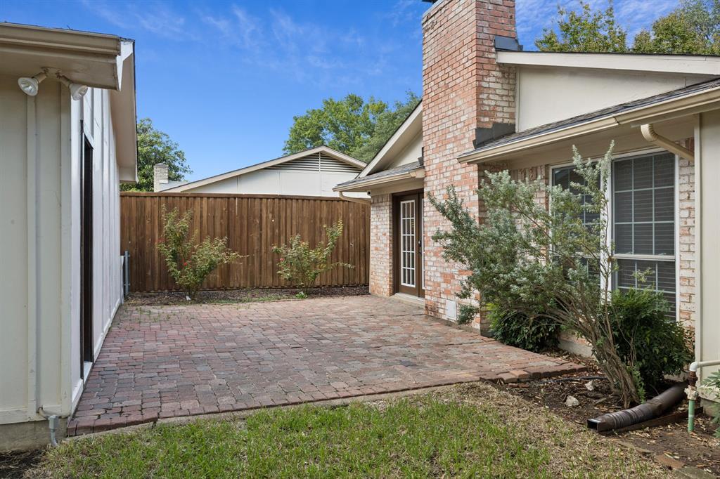 2015 Sandy Trail Richardson, TX 75080 - Photo 17 of 19 a front view of a house with garden