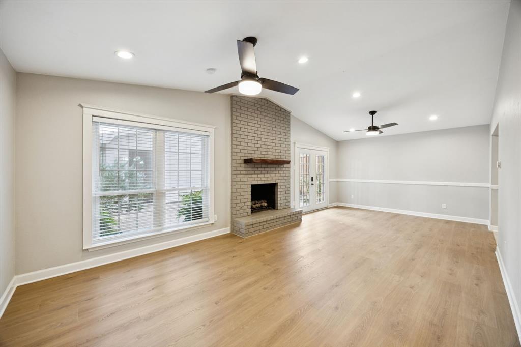 2015 Sandy Trail Richardson, TX 75080 - Photo 7 of 19 a view of an empty room with a fireplace and a window