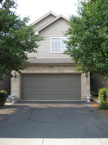 1444 Mackenzie Lane Elgin, IL 60120 - Photo 1 of 25 a front view of a house with a garage