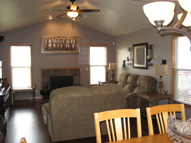 1444 Mackenzie Lane Elgin, IL 60120 - Photo 13 of 25 a living room with furniture a fireplace and a chandelier
