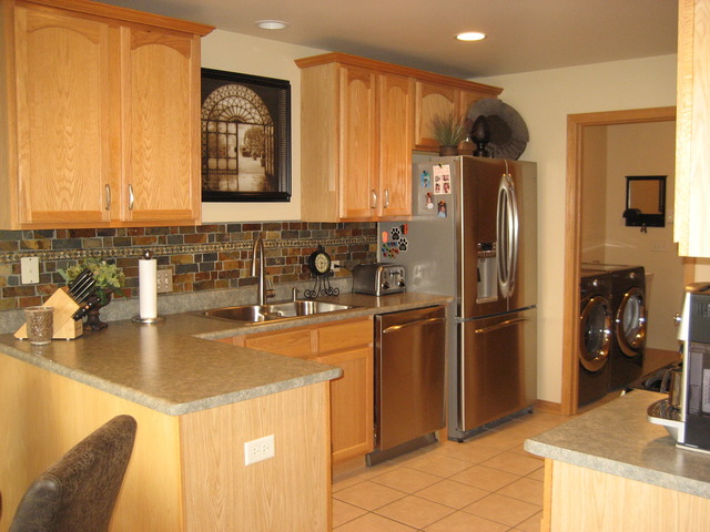 1444 Mackenzie Lane Elgin, IL 60120 - Photo 3 of 25 a kitchen with stainless steel appliances granite countertop a refrigerator a sink a stove and island