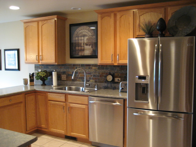 1444 Mackenzie Lane Elgin, IL 60120 - Photo 4 of 25 a kitchen with stainless steel appliances granite countertop a refrigerator a sink and white cabinets