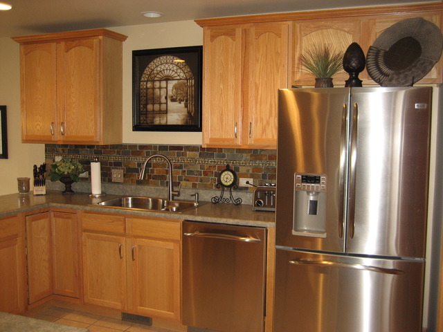 1444 Mackenzie Lane Elgin, IL 60120 - Photo 6 of 25 a kitchen with stainless steel appliances granite countertop a refrigerator and a sink
