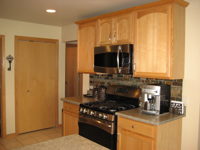 1444 Mackenzie Lane Elgin, IL 60120 - Photo 7 of 25 a kitchen with a stove and a microwave