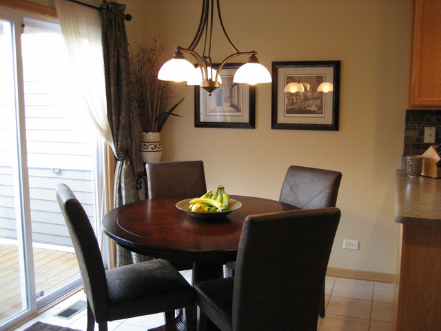 1444 Mackenzie Lane Elgin, IL 60120 - Photo 9 of 25 a view of a dining room with furniture and chandelier