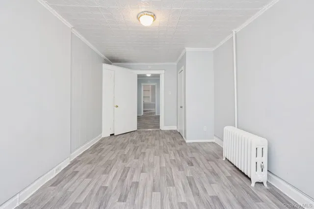 a view of hallway with wooden floor