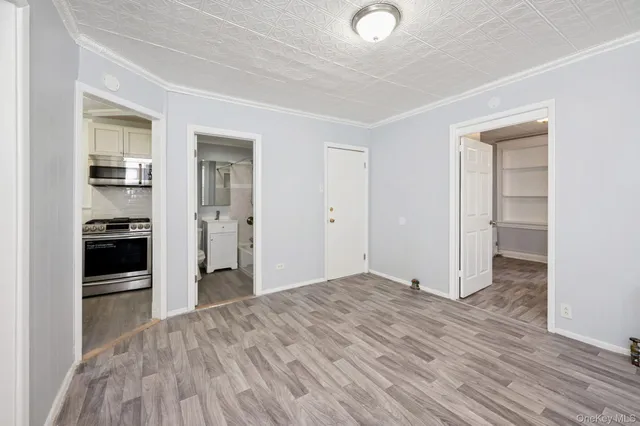 a view of a kitchen with wooden floor and a kitchen