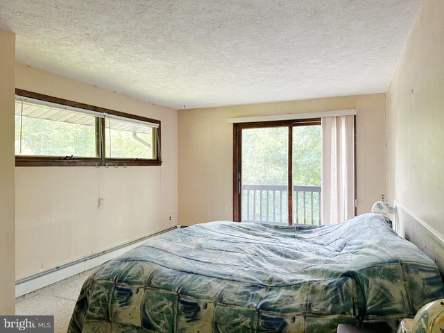 a bed room with a bed and a large window
